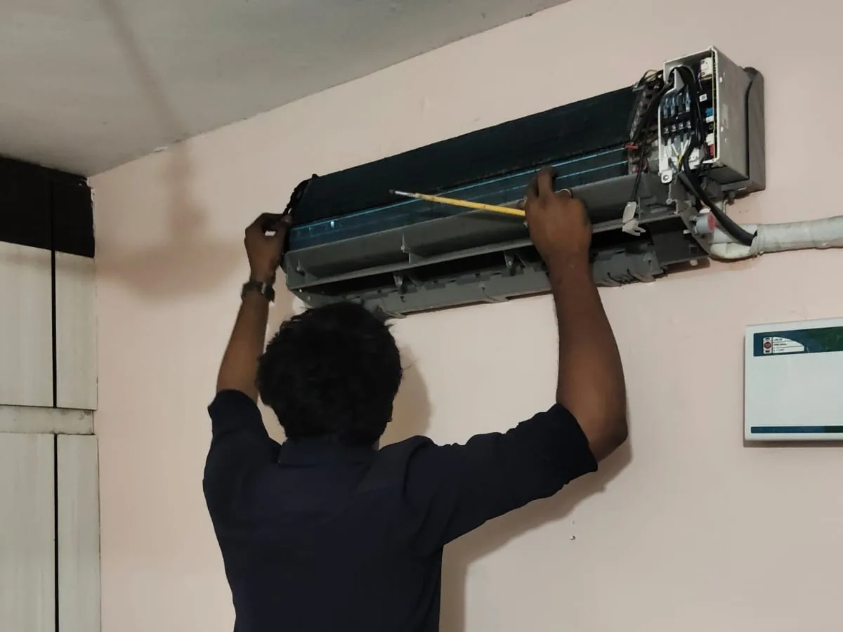 Elite Service Engineering technician repairing a home appliance